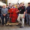 Surrounding a donated engine at Penn College’s Schneebeli Earth Science Center are (front row from left) diesel equipment technology instructors William P. Kilcoyne Jr. and David C. Johnson and Cummins Inc.'s Shawn M. Hricko, joined by students from Johnson’s Vehicle Electronics/Diagnostic Procedures lab.