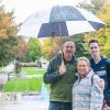 Pottstown residents Tom, Kim and Jason Francis pause during their soggy stroll for a portrait in campus exploration.