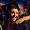 As faculty march to the stage, anticipation and fulfillment blend on a student's radiant face. 