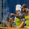 Darren J. Layre, a 2015 Pennsylvania College of Technology alumnus in culinary arts & systems and culinary arts technology, works with 2018 baking & pastry arts graduate Olivia M. Lunger at the 2019 Pennsylvania Farm Show. Layre will be among the successful alumni returning to the Farm Show stage in Harrisburg this month for the state’s 107th annual agricultural exposition. (Photo by Davey Rudy, PA Preferred)