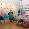 President Davie Jane Gilmour sits in The Gallery at Penn College, surrounded by donated dresses bound for Wise Options.