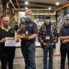 Competitors from Northern Tier Career Center – which won first place overall in the competition – accept a traveling trophy and certificate from Cleveland Brothers Equipment Co. Inc. representative Doug Wetzel (left).