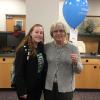 Student development assistant Kacey J. Shatzer (left) hand-delivers birthday wishes to donor Linda M. McFadden, assistant bursar.