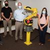 Pennsylvania College of Technology robotics & automation students and representatives from Elsner Engineering Works Inc. are seen with a Fanuc robot donated by the company. They are, from left, Jonah A. Ziegler, of Pottstown; Mike C. Danto III, of Rostraver Township, Westmoreland County; Bert Elsner II, company president and CEO; Lynneah Smith, director of human resources for Elsner Engineering; and Gerald A. Riley, of White Haven.