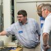 Adam C. Barilla, instructor of plastics and polymer technology at Penn College, demonstrates tensile testing to participants during the 19th annual Extrusion Seminar & Hands-On Workshop at the college’s Plastics Innovation & Resource Center.  (Photo by Tia G. La, student photographer)