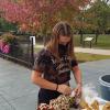 Serena V. Bergeron, an automotive technology management: collision repair concentration student from Lansdale, stuffs a plush leopard takeaway near a canopy of fall foliage.