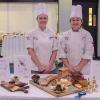 As part of Pennsylvania College of Technology’s annual Food Show, culinary arts technology students Summer L. Showers, left, of Aspers, and Chelsea L. Gray, of Marysville, receive the Chef Eugene Mattucci Best of Show award for their “Game Meats From the Hunt” platter and charcuterie board.