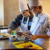 Pennsylvania College of Technology applied management student Mallory A. Hoffman (left), of Pottsville, and culinary arts student Alexa D. Scatamacchia, of Fleetwood, prepare their team’s dish in a combined cooking competition and lesson in equitably distributing nutritious food at the Central Pennsylvania Food Bank’s Williamsport branch.