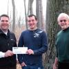 Scholarship recipient Garrett A. Krout, of McClure, is presented with a check by Steve Nagy, a recruiter and trainer at Davey Tree Expert Co., left, and Penn College forestry professor Dennis F. Ringling.