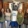 A half-dozen high school students hobnob with the Wildcat outside the ACC Auditorium.