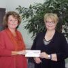Frontier Communications’ Jennifer Sherwood, left, presents a check to Debra M. Miller, Penn College’s director of corporate relations.