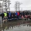 Puddles and jackets readily indicate the day's less-than-ideal racing conditions for the college contingent and fellow competitors.