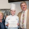 Jessica N. Felton holds her "Golden Ticket," seconds after Gerri F. Luke, interim dean of business and hospitality, and Chef Paul E. Mach, assistant professor of hospitality management/culinary arts, delivered the surprising news in her Cakes and Decorations class.