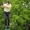 Trick shot performer Chuck “The Hit Man” Hiter dazzles a Williamsport Country Club crowd by maintaining his balance – and his eye on the ball – from a precarious perch.