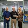 Ken Wawrzyniak, sales engineer for Haas Factory Outlet, presents a $15,000 grant check to Pennsylvania College of Technology on behalf of the Gene Haas Foundation. The grant will support scholarships for manufacturing students, as well as student competition teams. Accepting the grant on behalf of Penn College are Richard K. Hendricks, instructor and department head of automated manufacturing and machining, and Elizabeth A. Biddle, director of corporate relations.