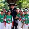 The very definition of a "good sport," Penn College Police Officer Jeffrey E. Kriner makes a fashion statement in a photo op with Mexico players from Guadalupe, Nuevo León. "Making a child smile takes little effort," Kriner explained, "but leaves a lifetime of memories."  