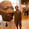 Artist Howard Tran with his burlap work titled “Hanh Trinh.” The piece was awarded first place in the “Art Alive!” Lycoming County Juried Art Exhibit at The Gallery at Penn College.