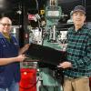 Howard W. Troup (left), instructor of automated manufacturing and machining at Pennsylvania College of Technology, and Jake C. Beatty, of Grove City, hold a milling machine bed protection cover that resulted from Beatty’s mold design. Beatty, who is scheduled to graduate in December with associate degrees in automated manufacturing technology & machine tool technology, designed the mold for a project in Troup’s Fixture Design & Fabrication class. An Ohio-based company used Beatty’s design 