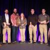 The two-year Penn College team displays its championship trophy (earned in the National Association of Home Builders’ student competition) at the International Builders’ Show in Las Vegas. From left are instructor Barney A. Kahn IV; students Joe J. Hetrick, of Painted Post, N.Y.; Drew P. Miller, of Williamsport; Hanna M. Gibson, of Allison Park; Nicholas T. Bonsell, of Tyrone; and Nathan I. Tabon, of Allison Park; and instructor Levon A. Whitmyer.