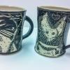 Two of the mugs to be auctioned at the ceramics exhibit at The Gallery at Penn College