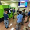Plastics professionals study an all-electric injection molding machine during the recent Injection Molding Processing Series hosted by Pennsylvania College of Technology and its Plastics Innovation & Resource Center. A dozen individuals representing five companies participated in the weeklong workshop.