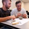 Thomas E. Ask, right, professor of industrial and human factors design at Penn College, works on a clay model with a student. Students from Jamestown Community College may transfer to Penn College and complete a Bachelor of Science in industrial and human factors design.