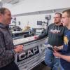 Automotive instructor Christopher A. Trapani, among the faculty for the new Mopar CAP major, lends an attentive ear.