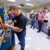 Thomas Horn (foreground), of Cardinal Systems Inc. in Schuylkill Haven, gets some hands-on exposure to Pennsylvania College of Technology's injection molding lab during a Summer 2021 Plastics Materials, Processing and Testing workshop on the college's main campus in Williamsport. (Editor’s note: The photo was taken before the college instituted an indoor masking protocol for everyone, regardless of vaccination status.)