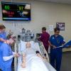 Penn College nursing students attend to SimMan, a patient simulator that can be programmed with a variety of symptoms to help the students practice a variety of health scenarios. In 2016-17, graduates of the nursing program passed national board exams at a rate that exceeded state and national pass rates.