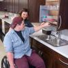 Alexis M. Conte, of Marcus Hook, a student in Penn College’s occupational therapy assistant major, demonstrates the occupational therapy assistant lab’s ADA-accessible cabinets with Nicholas R. Miller, an information assurance and cyber security student from Doylestown.