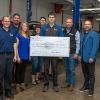 Scholarship recipient Derek T. Dreps (holding check) is surrounded by well-wishers in the Parkes Automotive Technology Center. From left are Chad Koch, general sales manager at Blaise Alexander Ford of Mansfield; Ralph Diodata, chief financial officer, Blaise Alexander Family Dealerships; Deni Cecco, regional manager for the Pennsylvania Automotive Association; Dreps’ parents, Kendra and Michael; and Aubrey and Adam Alexander.