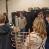 Daniel J. Harris, instructor of HVAC technology, talks with a group about classes in air conditioning and refrigeration while showing them a lab.