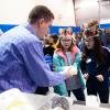 Guided by Brennan B. Wodrig, program manager for Pennsylvania College of Technology’s Plastics Innovation & Resource Center, fifth-graders visiting a recent Science Festival at the college examine a part produced by a tabletop rotational molder, which was funded by a PPL Foundation grant.