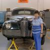 Eleanor Packard stands by the 1947 Packard Custom Super Clipper that has been donated to Penn College’s automotive restoration technology major.