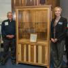 Showcasing a display case constructed of Pennsylvania lumber are, from left, Don Remmey, the business owner who donated the piece to Penn College; Abe Weaver, the woodworker who crafted it; Elizabeth A. Biddle, the college’s director of corporate relations; and Erich R. Doebler, laboratory assistant for forest technology at the college.