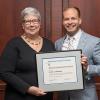 Penn College President Davie Jane Gilmour presents the Alumni Achievement Award to Kevin A. Hickman, a 2008 physician assistant graduate.