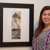 Ronni N. Warner, winner of the People's Choice award for "100 Works! - The Centennial Exhibit," stands next to her winning entry, "Past, Present, Future," a blend of three digital photographs, in The Gallery at Penn College. 