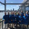 The Penn College plastics team at Braskem, in front of the Pittsburgh skyline