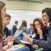 A simulated family meets and plans between “weeks.” From left are students Kaitlin L. Andersen, of Mastic, N.Y.; Matthew W. Stillman, of Kennett Square; and Sarah E. Boehnlein, of Lewisburg; and Brittany Fischer, United Way’s vice president for community action.