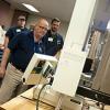 A participant in the Hands-On Rotational Molding Workshop at Penn College, Janin Lacasse, of Rotoplast, East Farnham, Quebec, conducts a tensile test on a specimen that was cut from a rotationally molded test box.