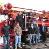 Alumnus Zachary D. Ball (left)and his Schramm Inc. co-worker Bruce D. Mackay (right) gather with first-year students in the college's heavy construction equipment technology: technician emphasis major.