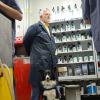 Faculty member Al Thomas with his service dog, Jesse, in the Collision Repair Lab at Penn College.