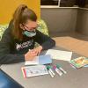 Student leader Sophia G. Wiest, of Butler, a dual major in entrepreneurial innovation and landscape/plant production technology, adds a personal touch to a stack of greeting cards. Among her campus activities, Wiest is a resident assistant, a Connections Link and a Wildcat Events Board team leader.