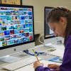 A camper pores through images for a make-believe coffee shop during last summer’s Graphic Design Summer Studio at Penn College.