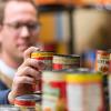 A Penn College Dining Services employee pulls food from The Cupboard's shelves for a student-client to pick up.