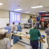 Christopher J. Gagliano (in front of equipment), program manager for the PIRC’s Thermoforming Center of Excellence at Penn College, leads a lab tour during a May workshop for industry professionals.