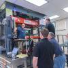 Christopher J. Gagliano (left) leads workshop attendees on a tour of the Plastics Innovation & Resource Center's Thermoforming Center of Excellence.