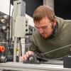 Thomas L. Snyder, of Weedville, employs hands-on skills in Pennsylvania College of Technology’s mechatronics lab. Snyder, who graduates with an associate degree in mechatronics technology on May 16, has strong family roots at the institution. 