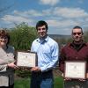 Plaques acknowledging scholarships from the mikeroweWORKS Foundation are presented to Penn College students Thomas M. DiGeronimo, Verona, N.J. (center), and Derek S. Black, of Trout Run, by Mary A. Sullivan, the college’s dean of natural resources management. (Photo by Carol A. Lugg, coordinator of matriculation and retention, School of Natural Resources Management)