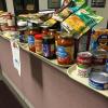 Cafeteria trays are piled with donated non-perishables in a Penn College office, an effort duplicated across campus in support of The Cupboard.